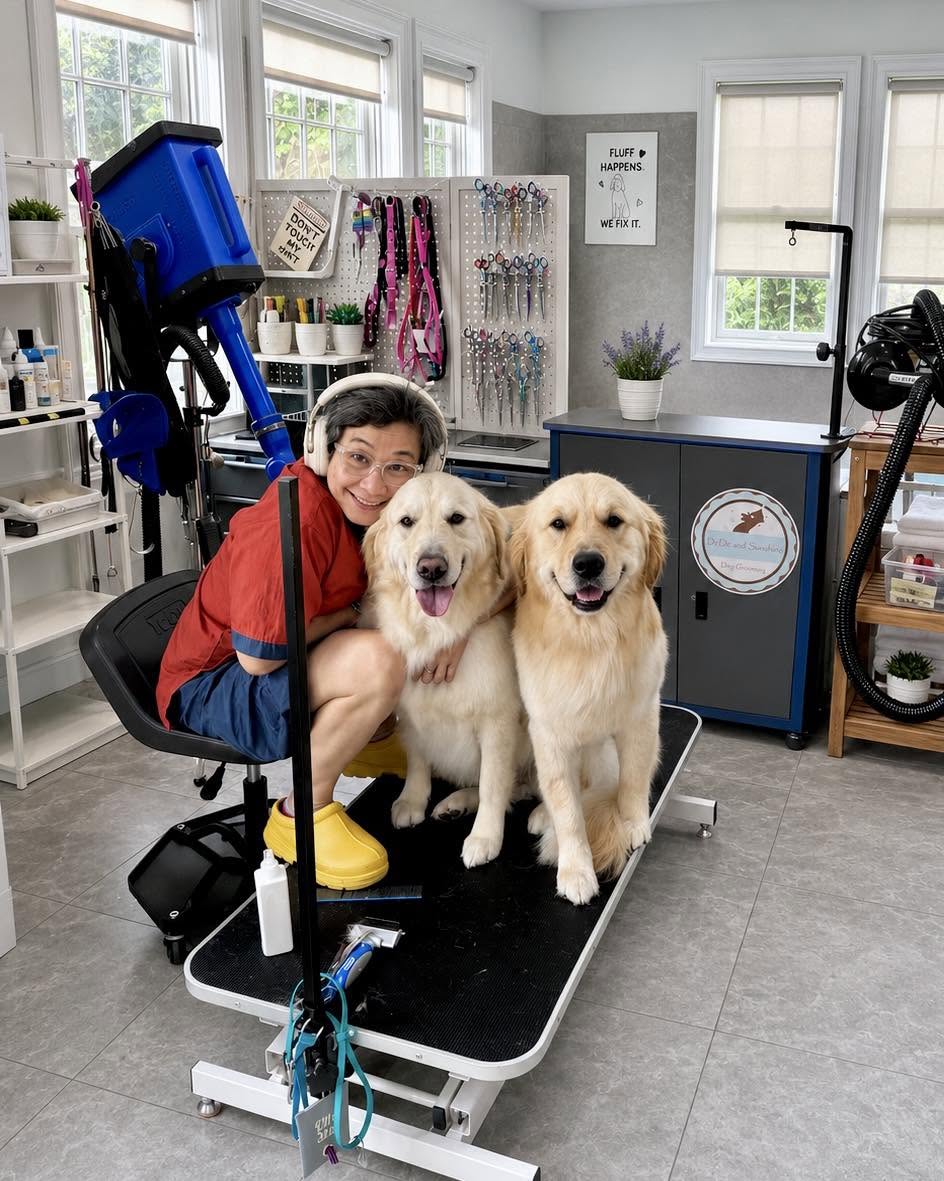 DeDe smiling with two happy golden retrievers, Zeke and Opie, fresh off the grooming table